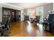 Spacious office area with hardwood floors, custom shelving, and comfortable seating at 330 Broad Leaf Ct, Johns Creek, GA 30022