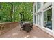 Expansive outdoor deck with dining table and chairs is perfect for entertaining amidst lush greenery at 330 Broad Leaf Ct, Johns Creek, GA 30022