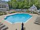 Sparkling swimming pool with ample lounge chairs, surrounded by lush greenery for a relaxing atmosphere at 330 Broad Leaf Ct, Johns Creek, GA 30022