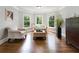 Bright sitting area with hardwood floors, a bay window and comfortable seating provides a cozy retreat at 330 Broad Leaf Ct, Johns Creek, GA 30022