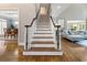 Elegant staircase with hardwood steps and black handrail connects the home's multiple levels at 330 Broad Leaf Ct, Johns Creek, GA 30022