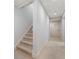 Carpeted staircase leads to a hallway with neutral walls and a white door at 330 Broad Leaf Ct, Johns Creek, GA 30022