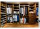 Well-organized walk-in closet with custom wood shelving, multiple hanging rods, drawers, and shoe racks at 330 Broad Leaf Ct, Johns Creek, GA 30022