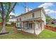 Charming back exterior of a home with a covered patio overlooking a lush, green backyard and mature trees at 604 Bassett Se Ct, Smyrna, GA 30080