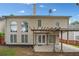 Back exterior view of home featuring a covered patio and a well-manicured backyard, great for relaxing outdoors at 604 Bassett Se Ct, Smyrna, GA 30080