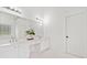White bathroom with double vanity, large mirror, and vanity seating at 604 Bassett Se Ct, Smyrna, GA 30080