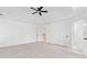 Large bedroom with vaulted ceiling, ceiling fan, plush carpet, and multiple doors at 604 Bassett Se Ct, Smyrna, GA 30080