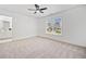 Bright bedroom with a ceiling fan and double window, features plush carpet and white walls at 604 Bassett Se Ct, Smyrna, GA 30080