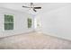 Spacious bedroom with carpeted floor, bright windows, and a ceiling fan at 604 Bassett Se Ct, Smyrna, GA 30080