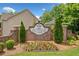 Welcome to Sutherlin Park, featuring a brick entrance sign surrounded by colorful flowers and manicured landscaping at 604 Bassett Se Ct, Smyrna, GA 30080
