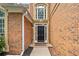 Elegant entryway featuring a black front door with sidelights and transom window at 604 Bassett Se Ct, Smyrna, GA 30080
