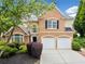 Charming brick home features a two-car garage and well-manicured landscaping at 604 Bassett Se Ct, Smyrna, GA 30080