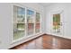 Bright living room featuring hardwood floors, multiple windows and door to the back yard at 604 Bassett Se Ct, Smyrna, GA 30080