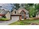 Charming two-story brick home with landscaped front yard and attached two car garage at 6845 Gledhill Way, Stone Mountain, GA 30087