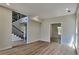 Open concept living space with hardwood flooring and staircase with iron spindles at 6845 Gledhill Way, Stone Mountain, GA 30087
