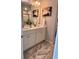 Bright bathroom featuring double sinks, neutral countertops, modern fixtures, and contemporary artwork at 1195 Park Center Cir, Austell, GA 30168