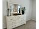 Well-lit bedroom features a dresser, mirror, decor, and carpet flooring at 1195 Park Center Cir, Austell, GA 30168