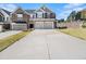 Spacious townhome boasts a two-car garage, ample driveway, and attractive architectural details at 1195 Park Center Cir, Austell, GA 30168