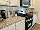 Well-equipped kitchen features stainless steel appliances, granite countertops, and ample cabinet space at 1195 Park Center Cir, Austell, GA 30168