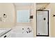 Bright bathroom featuring white cabinets, soaking tub, and frameless shower at 2821 Amhurst Nw Way, Kennesaw, GA 30144