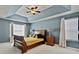 Spacious bedroom with tray ceiling, plush carpet, and serene lighting at 2821 Amhurst Nw Way, Kennesaw, GA 30144