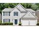 Charming two-story home with gray siding, dark shutters, and a two-car garage, framed by mature trees at 2821 Amhurst Nw Way, Kennesaw, GA 30144