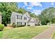 Well-maintained lawn frames a two-story house with a two-car garage, showcasing the property's pleasant neighborhood setting at 2821 Amhurst Nw Way, Kennesaw, GA 30144