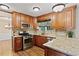 Updated kitchen featuring granite countertops, stainless steel appliances, and a view of the backyard, perfect for chefs at 2821 Amhurst Nw Way, Kennesaw, GA 30144