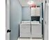 Functional laundry room with washer, dryer, and built in shelving at 2821 Amhurst Nw Way, Kennesaw, GA 30144