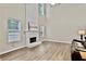 Spacious living room featuring a fireplace, soaring ceilings, and natural light, creating an inviting atmosphere at 2821 Amhurst Nw Way, Kennesaw, GA 30144