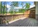 Charming outdoor living space featuring a stained wood deck and wooded views at 286 Blue Pointe Ct, Suwanee, GA 30024