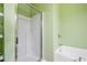 Bright bathroom featuring a glass shower and separate soaking tub at 286 Blue Pointe Ct, Suwanee, GA 30024