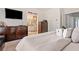 Bright bedroom featuring a large dresser and an ensuite bathroom at 286 Blue Pointe Ct, Suwanee, GA 30024