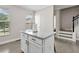 Bright kitchen island featuring granite countertops and white cabinetry at 286 Blue Pointe Ct, Suwanee, GA 30024