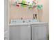 Laundry room with washer, dryer, and storage shelves at 286 Blue Pointe Ct, Suwanee, GA 30024