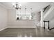 Open living room featuring modern lighting and access to the upstairs at 286 Blue Pointe Ct, Suwanee, GA 30024