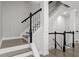 Elegant staircase featuring white risers, wood treads, and black handrail at 286 Blue Pointe Ct, Suwanee, GA 30024