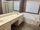 Bathroom with double vanity, large mirror, and soaking tub at 3222 Wyndham Park Ct, Decatur, GA 30034