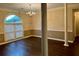 Elegant dining room featuring a chandelier, hardwood floors, and large windows for ample natural light at 3222 Wyndham Park Ct, Decatur, GA 30034