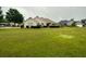 Well-manicured lawn in front of single-story home with a light-colored exterior, complemented by lush, trimmed greenery and a symmetrical facade at 3222 Wyndham Park Ct, Decatur, GA 30034