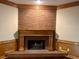Close-up of a brick fireplace with a wooden mantel at 3222 Wyndham Park Ct, Decatur, GA 30034