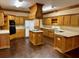 Spacious kitchen with wooden cabinetry, a center island cooktop, and modern appliances at 3222 Wyndham Park Ct, Decatur, GA 30034