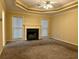 Cozy living room with a marble fireplace, plush carpet, and a ceiling fan at 3222 Wyndham Park Ct, Decatur, GA 30034