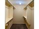 Spacious walk-in closet features built in storage solutions with shelves and racks at 3222 Wyndham Park Ct, Decatur, GA 30034