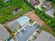 Aerial view of the community amenities, including a pool, parking area, and dog park by a scenic pond at 3760 Oxford Cir, Doraville, GA 30340