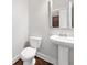 A half bath featuring a pedestal sink and framed mirror at 3760 Oxford Cir, Doraville, GA 30340