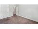 Empty bedroom featuring neutral carpet, base molding, and white doors at 3760 Oxford Cir, Doraville, GA 30340