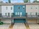 Rear exterior of the townhome featuring a deck above the garage at 3760 Oxford Cir, Doraville, GA 30340