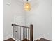 Bright hallway with hardwood floors, stylish lighting, and stairs with iron railing at 3760 Oxford Cir, Doraville, GA 30340