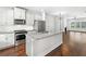 Open-concept kitchen with stainless steel appliances, granite counters, and hardwood floors at 3760 Oxford Cir, Doraville, GA 30340